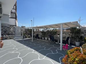 a patio with a canopy on top of a building at Villa Pavlina in Karterados
