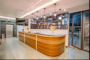 a kitchen with a large wooden bar in a building at Melanta Hotel in Sầm Sơn