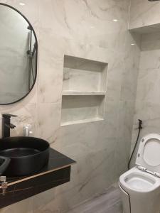 a bathroom with a sink and a toilet and a mirror at Cát Tiên Hotel in Cat Tien