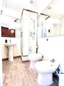 a bathroom with a toilet and a sink and a shower at Mia House Roma in Rome +53 photos