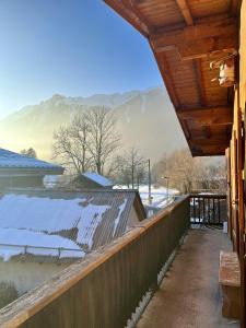 Un porche de una casa con nieve en el techo. en Le Chaney - T2 dans chalet - Massif du Mont-Blanc, en Chamonix-Mont-Blanc