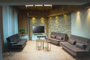 salon z 2 kanapami i telewizorem w obiekcie EMMA´s Chalet w Mayrhofen