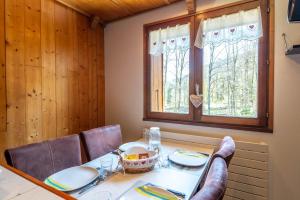 a dining room with a table and chairs and a window at Smartstay au reve Savoyard - Studio N-6 in Morillon