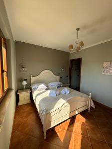 a bedroom with a bed with towels on it at CS Holiday in Castelnuovo Berardenga