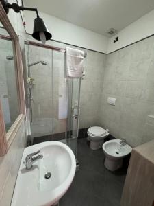 a bathroom with a sink and a toilet and a shower at CS Holiday in Castelnuovo Berardenga