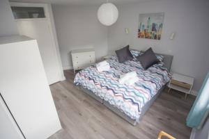 a small bedroom with a bed with pillows at Forest Park in Courtown