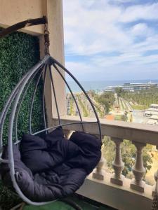 a swing on a balcony with a view of the ocean at Sea and Montaza Palace view 2 bedrooms apartment alexandria,2 full bathrooms, with 2 AC and 1 Stand Fan, wifi, 4 blankets available in Alexandria