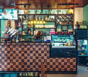 a bar in a restaurant with a counter at BELLADAMA HOTEL in San Carlos