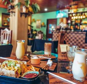 a table with a plate of food and some drinks at BELLADAMA HOTEL in San Carlos +24 photos