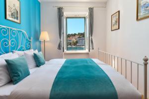 a bedroom with a large bed and a window at Sun Spalato Fara in Hvar