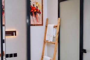 a room with a ladder and a painting on the wall at Samawa Living in Paje