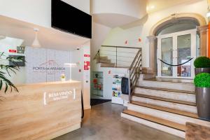 a store front with stairs and a tv on the wall at Porta da Arrábida Suites in Palmela +73 photos
