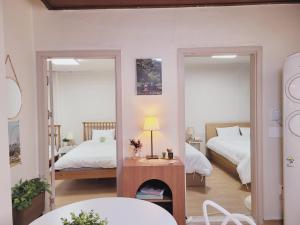 a bedroom with two beds and a fireplace at SNU Stay in Seoul