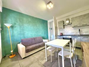 ein Wohnzimmer mit einem Sofa und einem Tisch in der Unterkunft Be Your Home - Casa Vetulonia in Santa Marinella