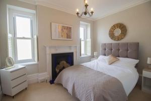 a bedroom with a bed with a fireplace and a mirror at Beach Haven Apartment By Air Premier in Seaford