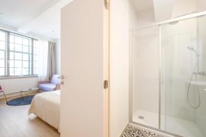 a bathroom with a shower and a bedroom with a bed at THE GOOD FLATS in Brussels