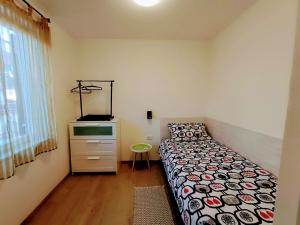 una piccola camera con letto e cassettiera di Porec Travel Stop a Poreč (Parenzo)