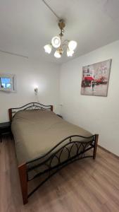 a bedroom with a bed and a ceiling fan at Your Cozy Family-Friendly Flat in Vibrant Riga in Riga