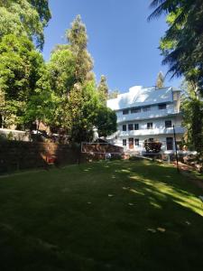 un edificio con un patio verde delante de él en Seattle Garden Resort - KolliHills en Kolli Hills