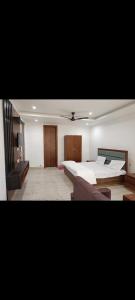 - une grande chambre avec un lit et un canapé dans l'établissement DAYA RESORT, à Ayodhya