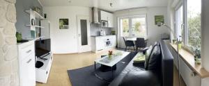a living room with a couch and a table at Appartement Pension Schüßler in Waldeck