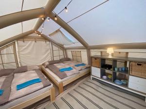 a bedroom with two beds in a tent at Mara Camping Mobile Homes in Liptovský Trnovec