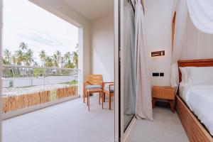 a bedroom with a bed and a view of the ocean at Samawa Living in Paje