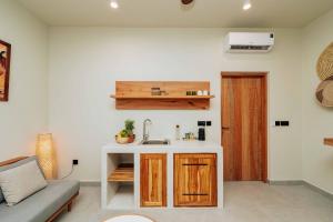 a kitchen and living room with a sink and a couch at Samawa Living in Paje