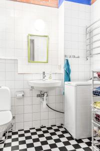 a white bathroom with a sink and a toilet at B&B Eco-Village 12 min from city in Stockholm