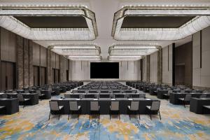 a large room with chairs and a projection screen at JW Marriott Hotel Taiyuan in Taiyuan