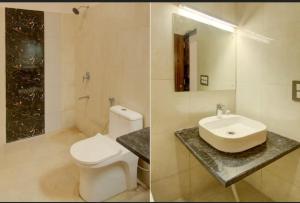 a bathroom with a white toilet and a sink at Hotel Giriraj Palace in Jaipur +25 photos
