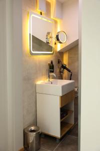 a bathroom with a white sink and a mirror at Gardenmode Airport Hotel in Taşoluk
