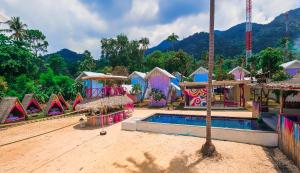 a resort with a swimming pool and a playground at Slumber Resort Koh Chang in Trat