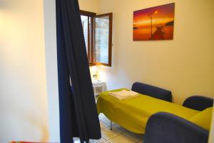 a room with a yellow bed and a window at VILLA ROMANTIC COVE vista mozzafiato sul mare in Latina
