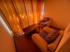 a small living room with a couch and a table at Guza Ethnic Resort in Leh