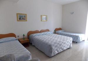 Habitación con 3 camas en una habitación en Hotel Federico II en Nápoles