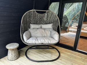 a wicker chair sitting in the corner of a room at Badger at Owlet Hideaway - with Hot Tub, near York in Seaton Ross