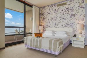 a bedroom with a bed with a floral wallpaper at Pestana Bahia Praia Nature & Beach Resort in Vila Franca do Campo