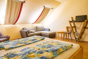 a living room with two beds and a couch at Napkelte Vendégház in Orfű