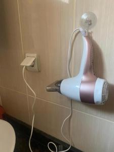 a hair dryer hanging on the wall of a bathroom at Duplex near the Cleopatra Beach in Alanya in Alanya