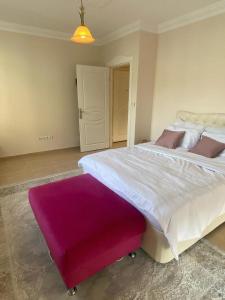 a bedroom with a large bed with a purple rug at Duplex near the Cleopatra Beach in Alanya in Alanya