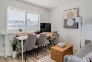 a living room with a desk and a table with chairs at Blueground Oakland ac walk to dining shops SFO-1705 in Oakland