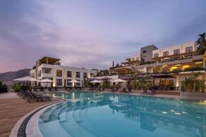 Ramada Resort by Wyndham Bodrum في بيتيس: مسبح كبير امام الفندق