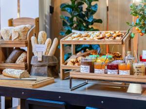 a display of bread and pastries on a table at Novotel Evry Courcouronnes in Evry-Courcouronnes