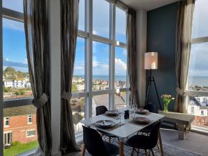 a dining room with a table and a large window at 2 Bed in Teignmouth 77321 in Teignmouth