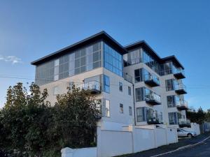 a tall white building with a black roof at 2 Bed in Teignmouth 77321 in Teignmouth