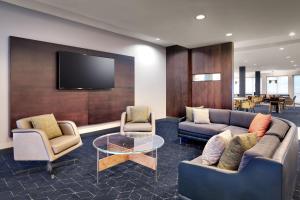 a living room with two couches and a tv at Courtyard by Marriott Johnson City in Johnson City