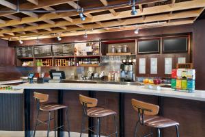 a bar with brown stools in a restaurant at Courtyard by Marriott Johnson City in Johnson City