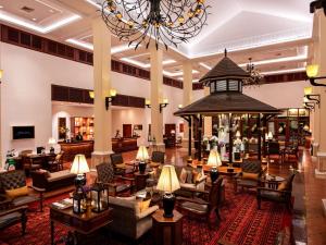 a lobby of a hotel with couches and chairs at Sofitel Angkor Phokeethra Golf & Spa Resort in Siem Reap