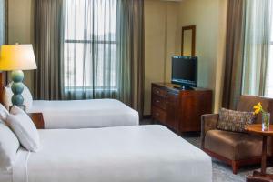 a hotel room with two beds and a television at Hyatt Regency Buffalo in Buffalo